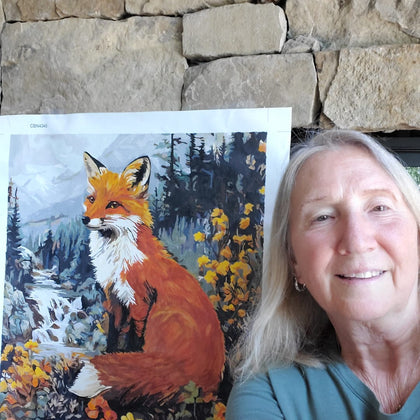 Customer with her finished paint by numbers fox painting