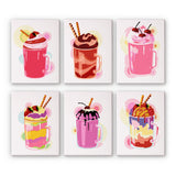 Set of six colorful mini paint by numbers kits of milkshakes on a white background