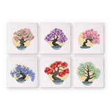 Set of six square mini paint by numbers with colorful tree designs on a white background