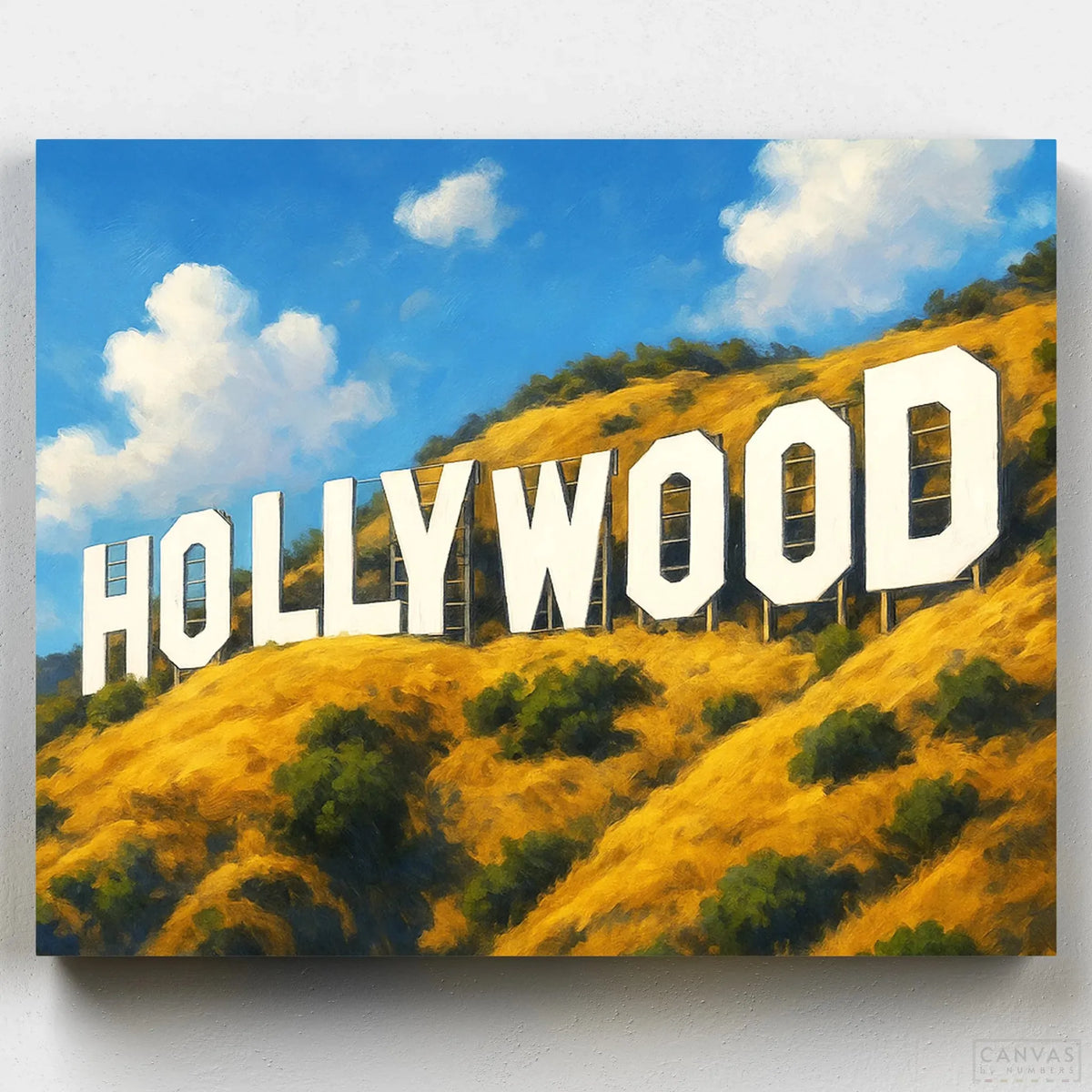  A paint-by-numbers kit of the Hollywood sign on a hill with blue sky and clouds