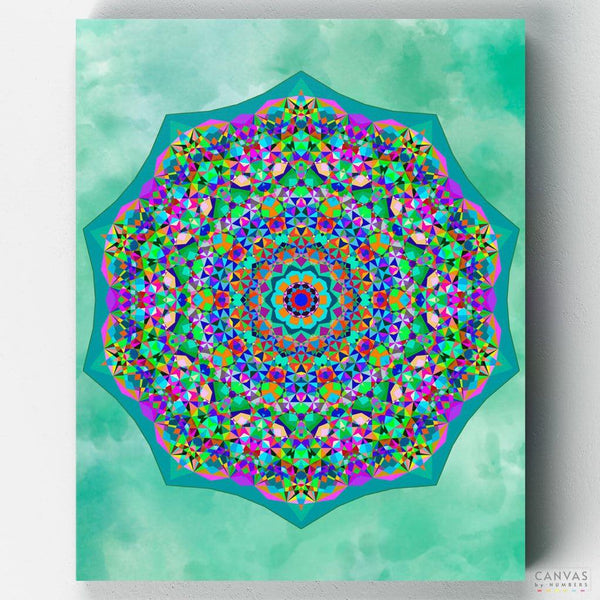 Acceptance Mandala Painting Kit by Canvas by Numbers. A green, pink and blue kaleidoscope geometric mandala painting on a green background. 