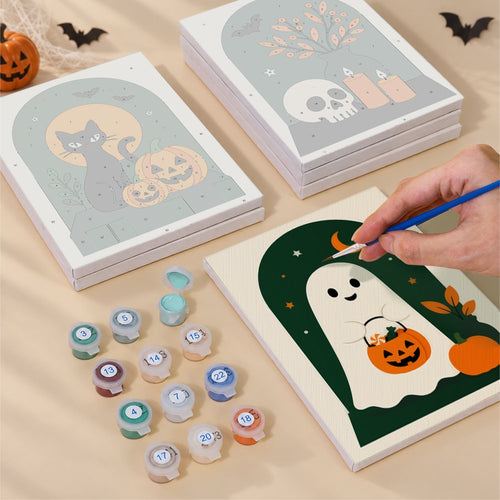 Blank numbered Arched Window Halloween canvases next to acrylic paint pots