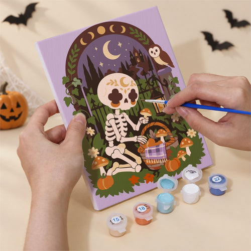 Hands painting a Bohemian Bones design by numbers