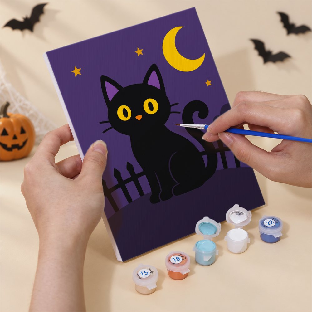 Hands painting a Bold Halloween Shapes design by numbers