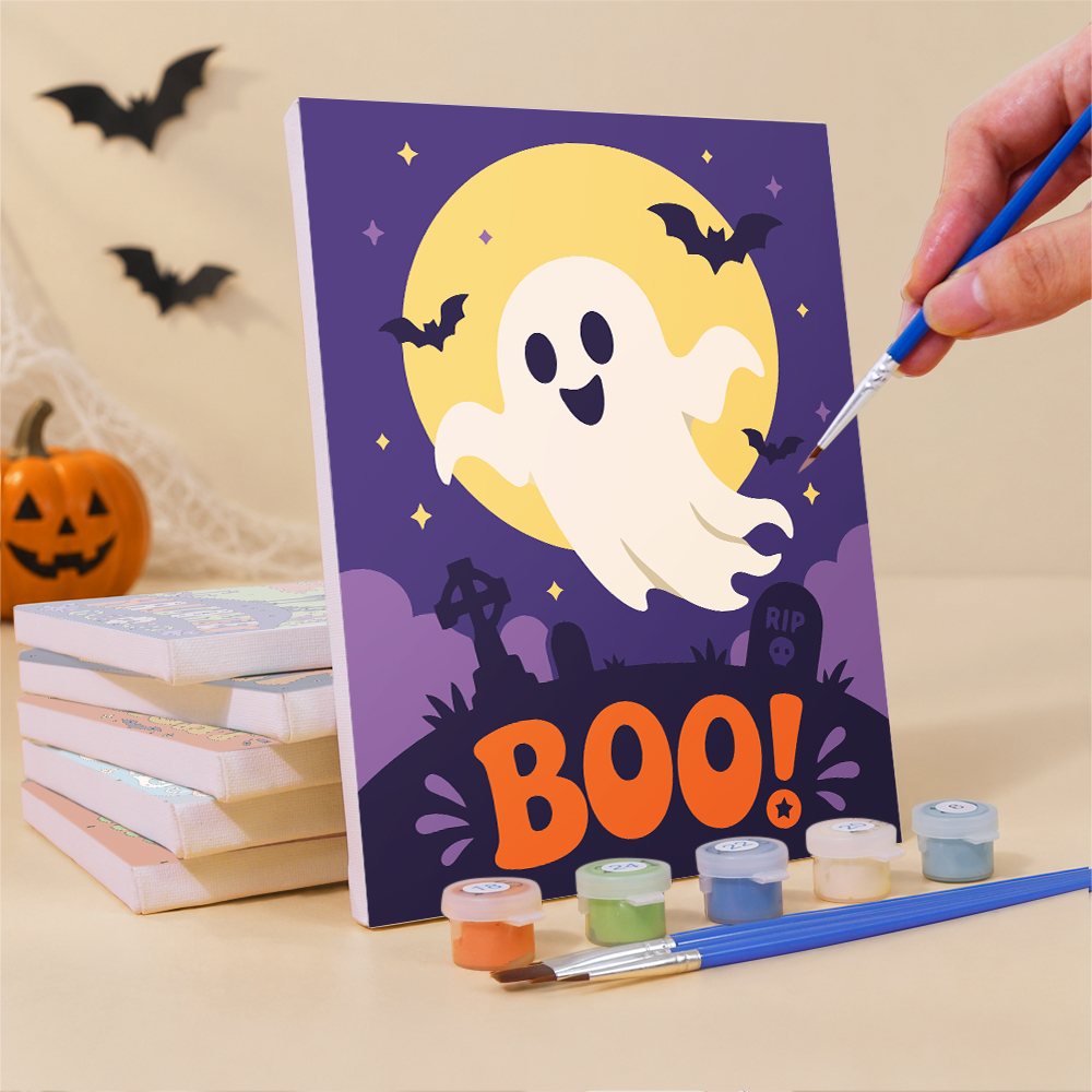 Painting one of the Boo! Hand Lettering mini canvases with a fine brush