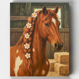Painting of a brown horse with a braided mane featuring white flowers, standing next to hay bales.