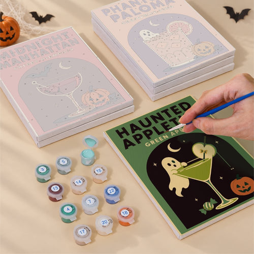 Blank numbered Cocktail Hour Hauntings canvases next to acrylic paint pots