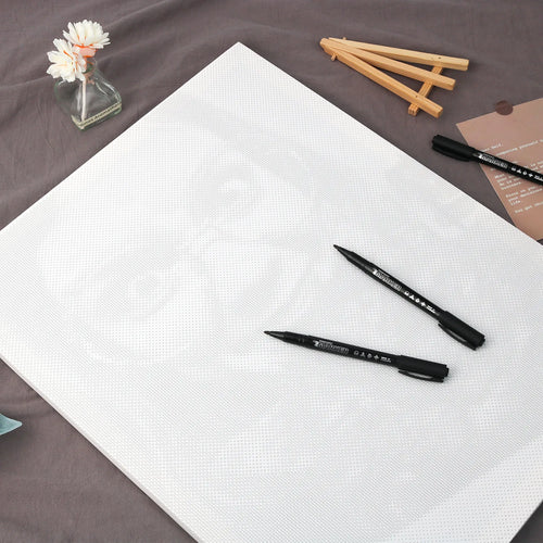 Blank dot-printed canvas with markers, ready to personalize
