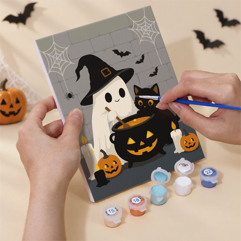 Hands painting a Ghosts & Kittens by the Cauldron design by numbers