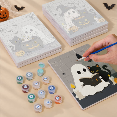 Blank numbered Ghosts & Kittens by the Cauldron canvases next to acrylic paint pots
