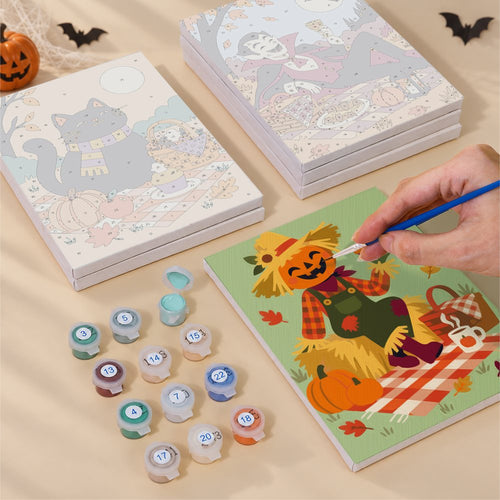 Blank numbered Gingham Blanket Ghouls canvases next to acrylic paint pots