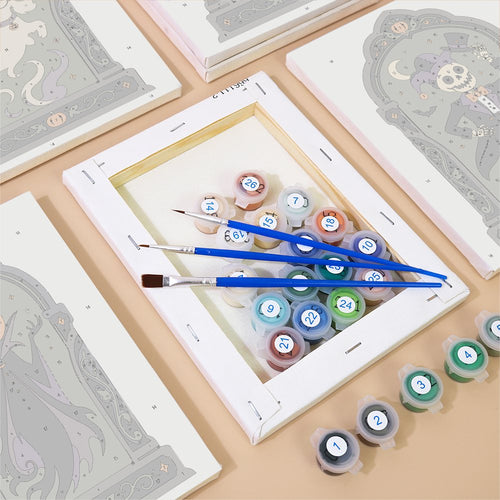 Numbered canvases, paint pots and brushes from the Gothic Arch Portraits set
