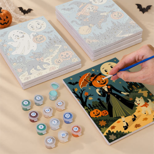 Blank numbered Grinning Moon Village canvases next to acrylic paint pots