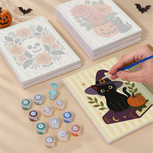Blank numbered Marigold & Moon Florals canvases next to acrylic paint pots