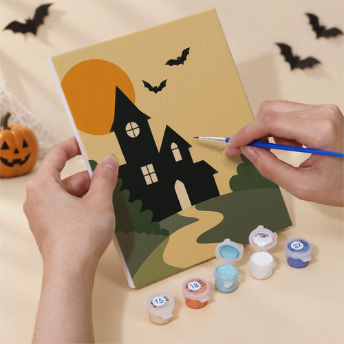 Hands painting a Mid-Century Hauntings design by numbers