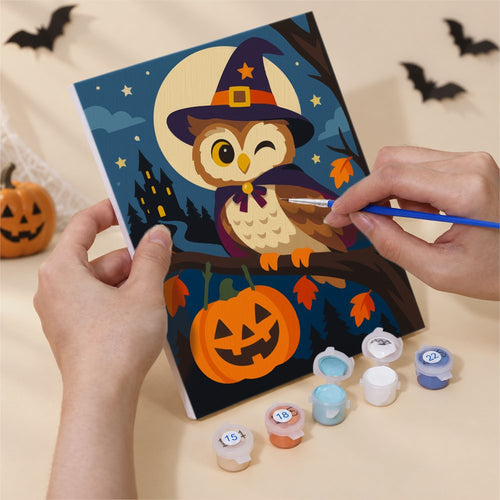 Hands painting an Old-Time Autumn Storybook design by numbers