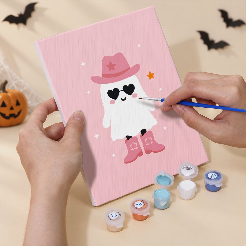 Hands painting a Pretty in Pink Ghosts design by numbers