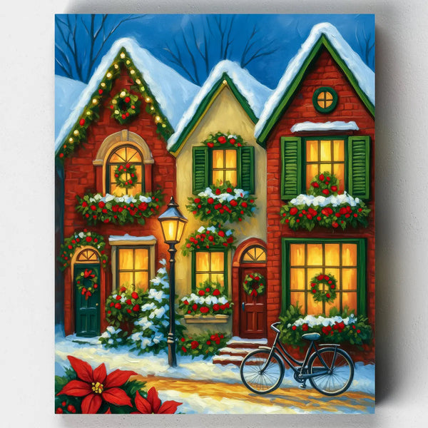 Cozy Christmas house paint by numbers kit featuring a warmly lit brick home decorated with wreaths, garlands, and snow-covered greenery in a festive winter setting.