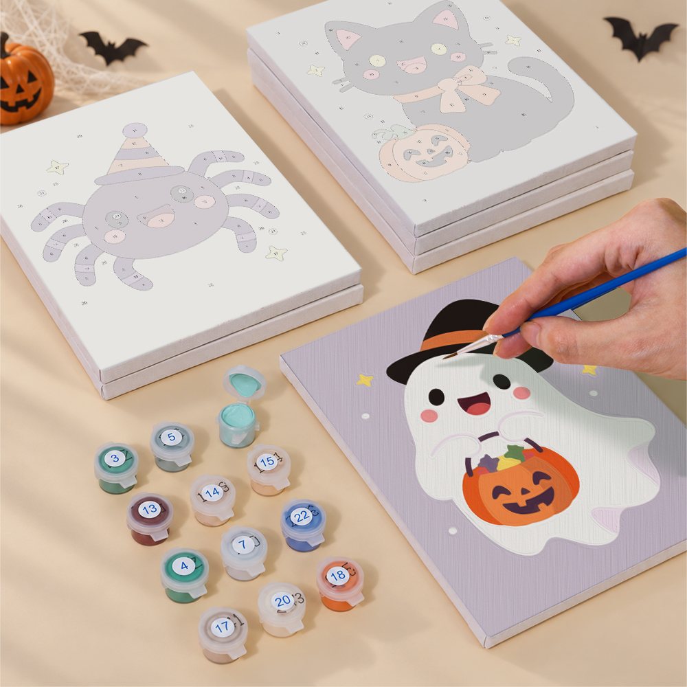 Blank numbered Soft Kawaii Halloween canvases next to acrylic paint pots
