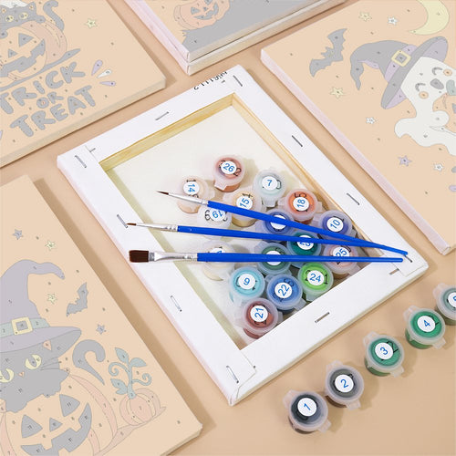 Numbered canvases, paint pots and brushes from the Tangerine Ghost Gang set