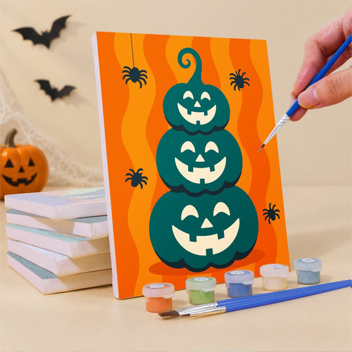 Painting one of the Teal & Tangerine Halloween mini canvases with a fine brush
