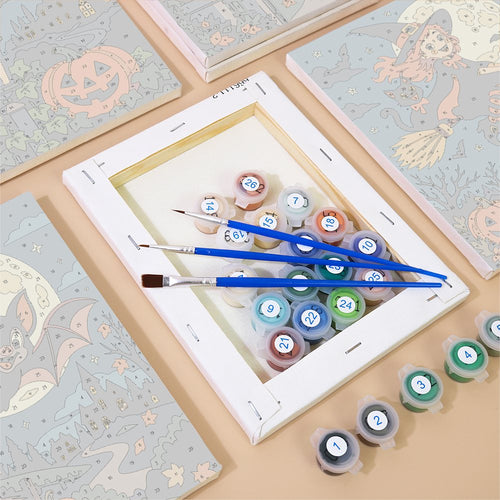 Numbered canvases, paint pots and brushes from the Teal Night Skeleton Dance set