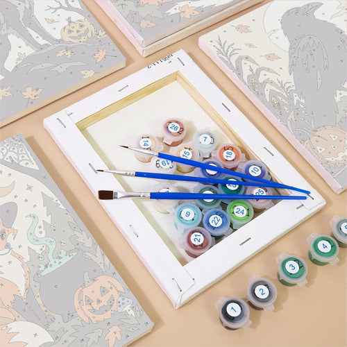 Numbered canvases, paint pots and brushes from the Wolf, Owl & Fox by Moonlight set